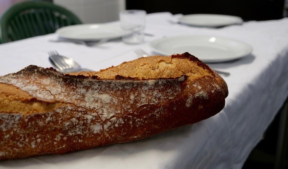 Detail of fresh baguette for kitchen staff lunch inside French school cafeteria kitchen.