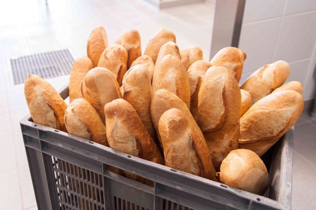 Crate of fresh baguettes for French school lunch.