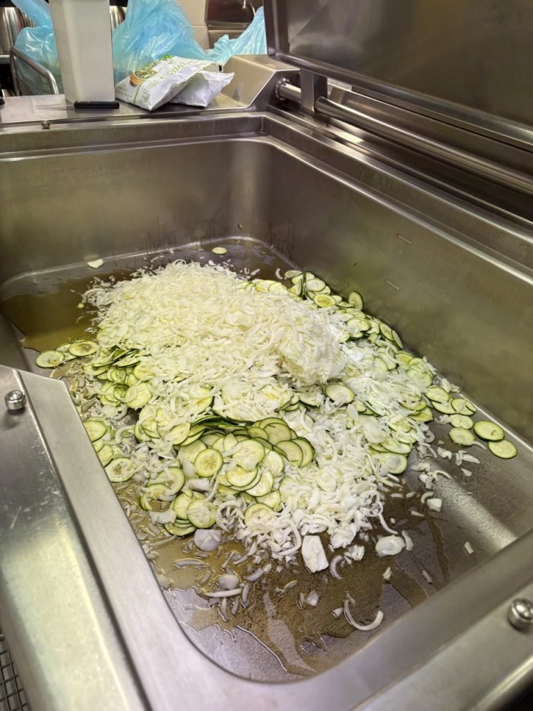 Ingredients being prepared to make zucchini soup for French school lunch.