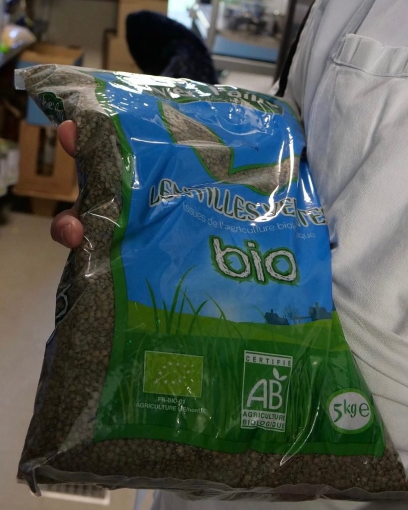 Large bag of organic lentils in the pantry of French school cafeteria kitchen.