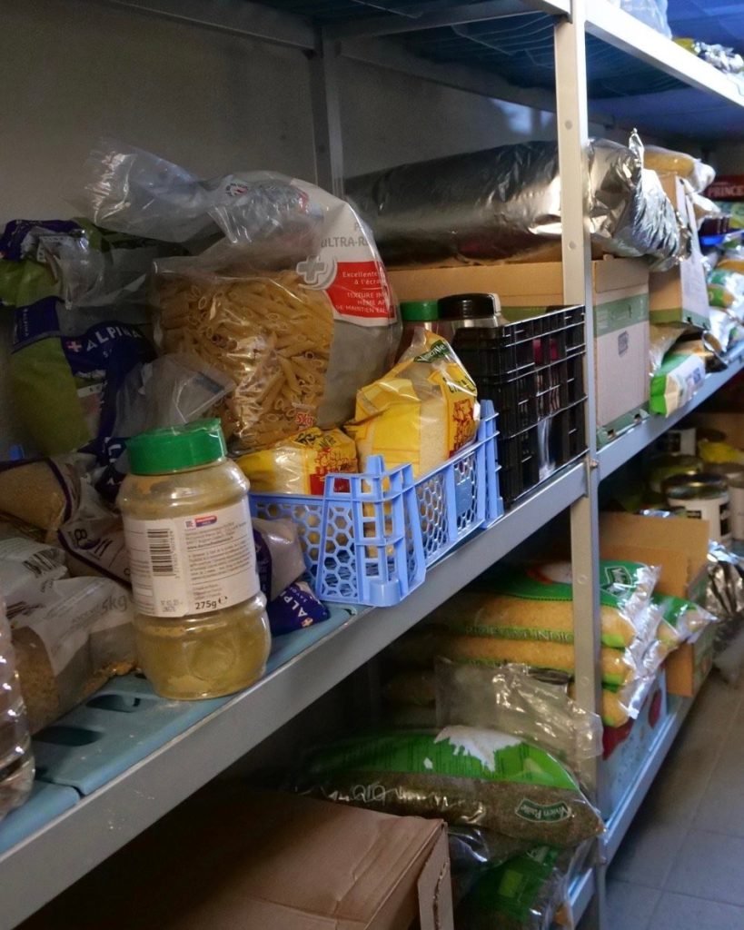 Dry goods food items inside pantry of French school cafeteria kitchen.
