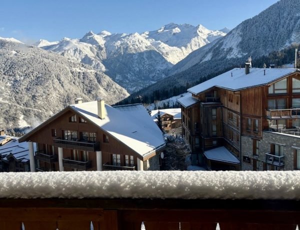 View of beautiful snowy Alps from a chalet balcony.