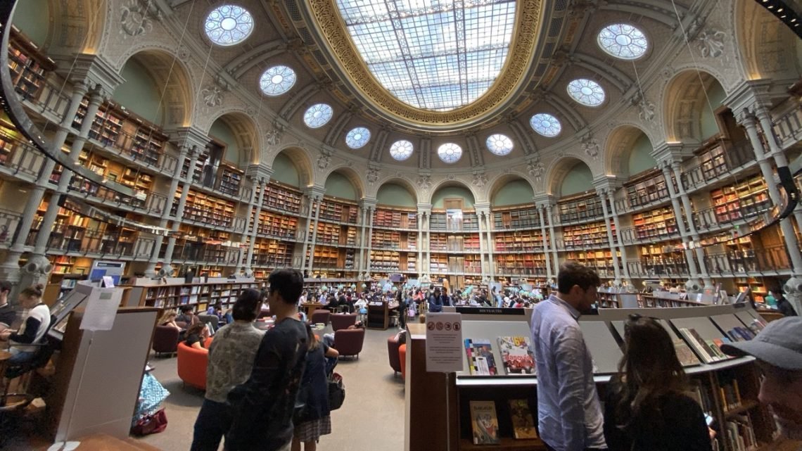 Library reading room in Paris with desks, bookshelves, french books