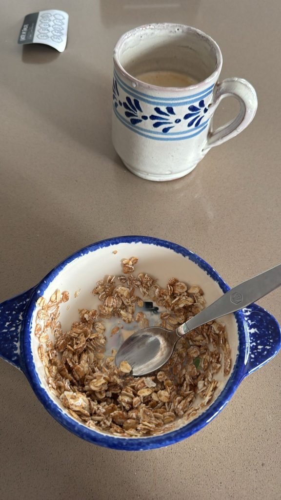 Bowl of muesli with milk served with coffee for a simple French breakfast