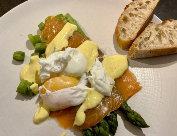 Typical dinner of fish, eggs, vegetables, french bread representing what French women eat in a day at dinner time