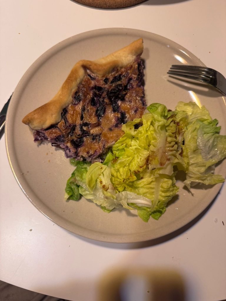 Quiche with green salad typical of what French women eat in a day