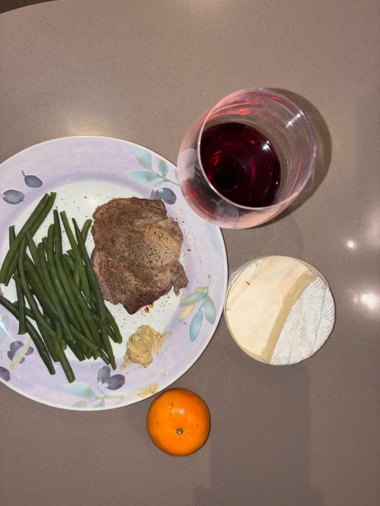 Steak with green beans and cheese typical of what French women eat in a day at dinner time