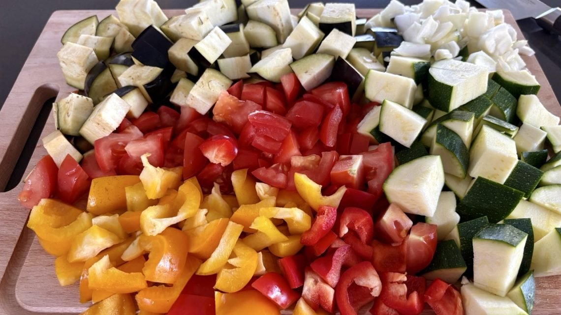 Easy baked ratatouille recipe ingredients with zucchini, eggplant, tomatoes, and peppers