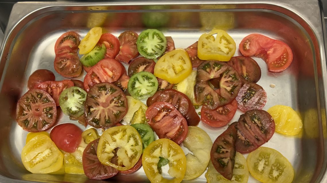 Tray of fresh tomatoes prepared for a French public school lunch.