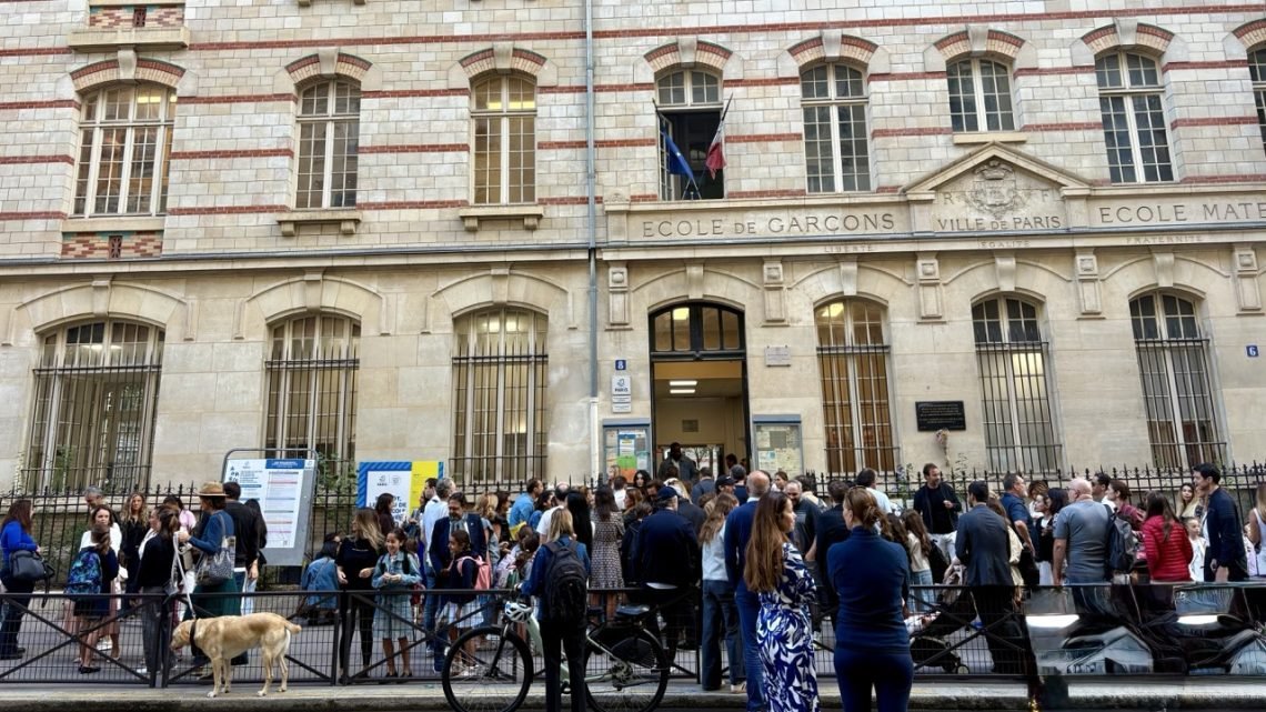 Families outside a Paris public school on the first day of school