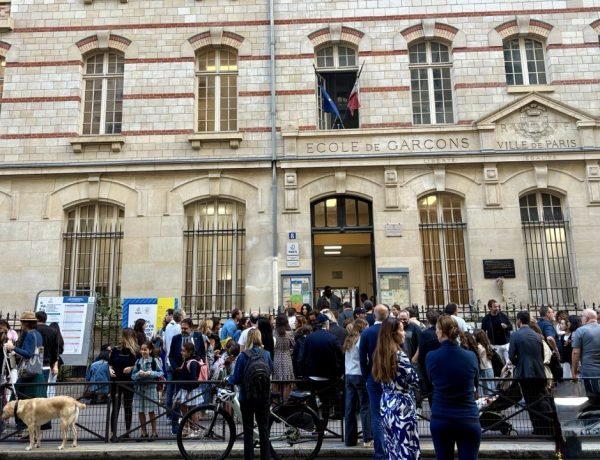 Families outside a Paris public school on the first day of school